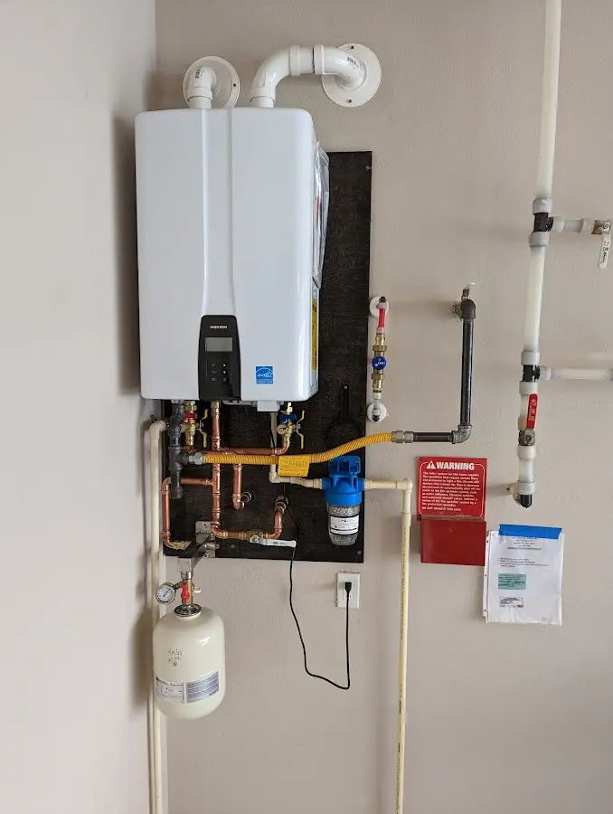 Professional plumber installing copper piping in a Newstead home